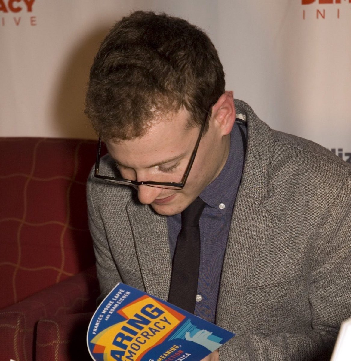 Adam Eichen signing copies of Daring Democracy